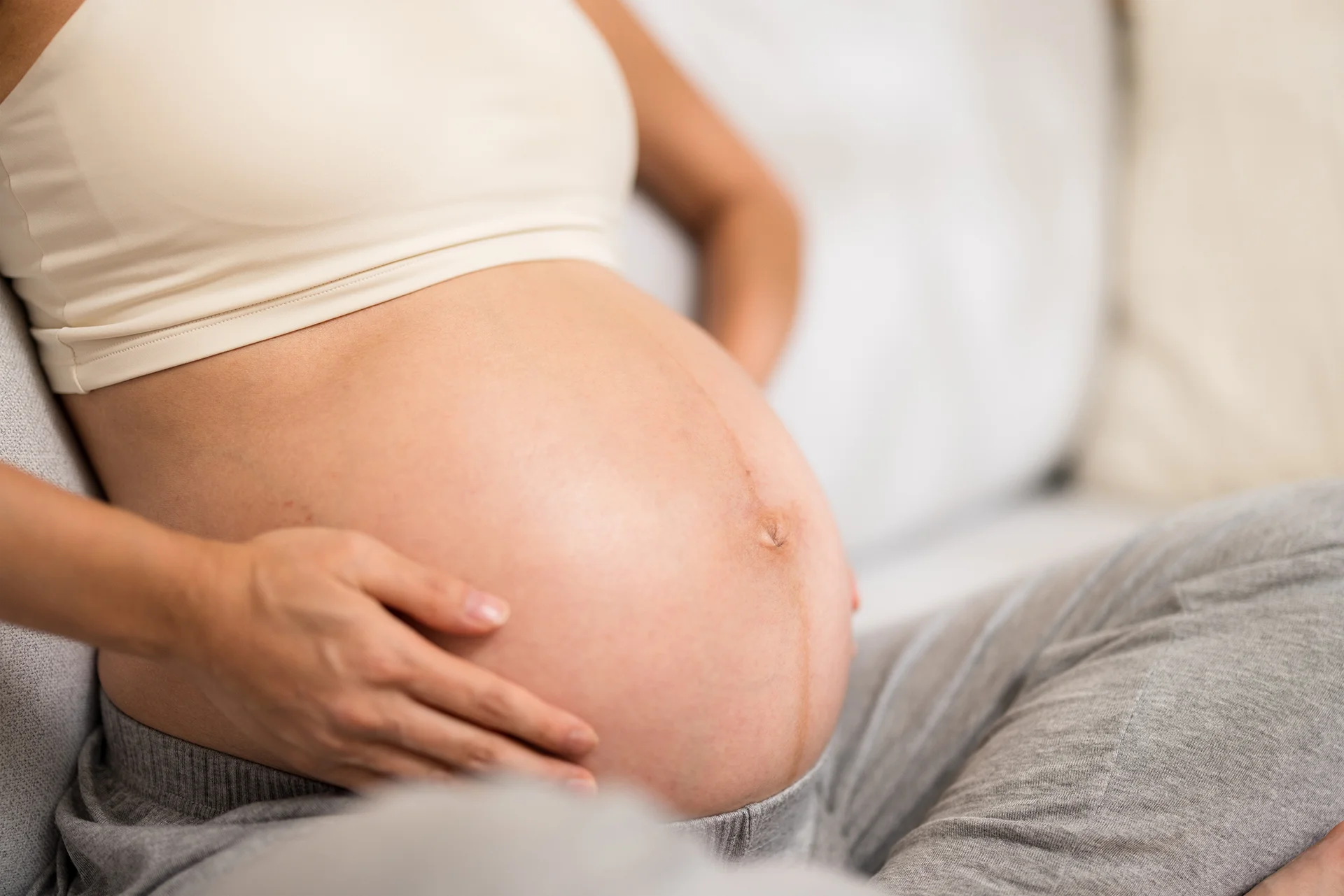 pregnant woman resting hand on baby bump