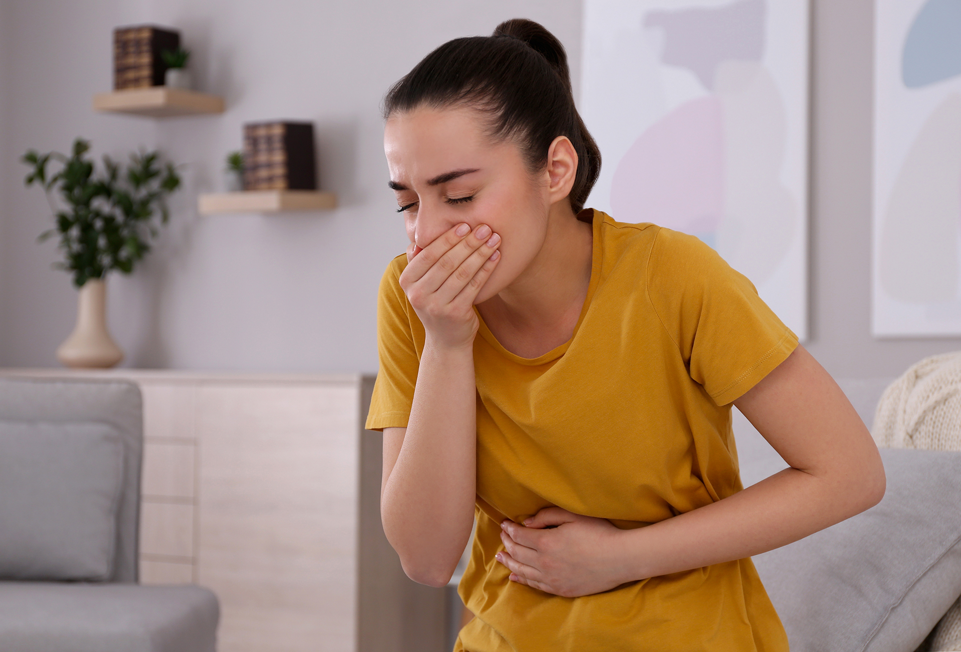 young woman feeling sick at home
