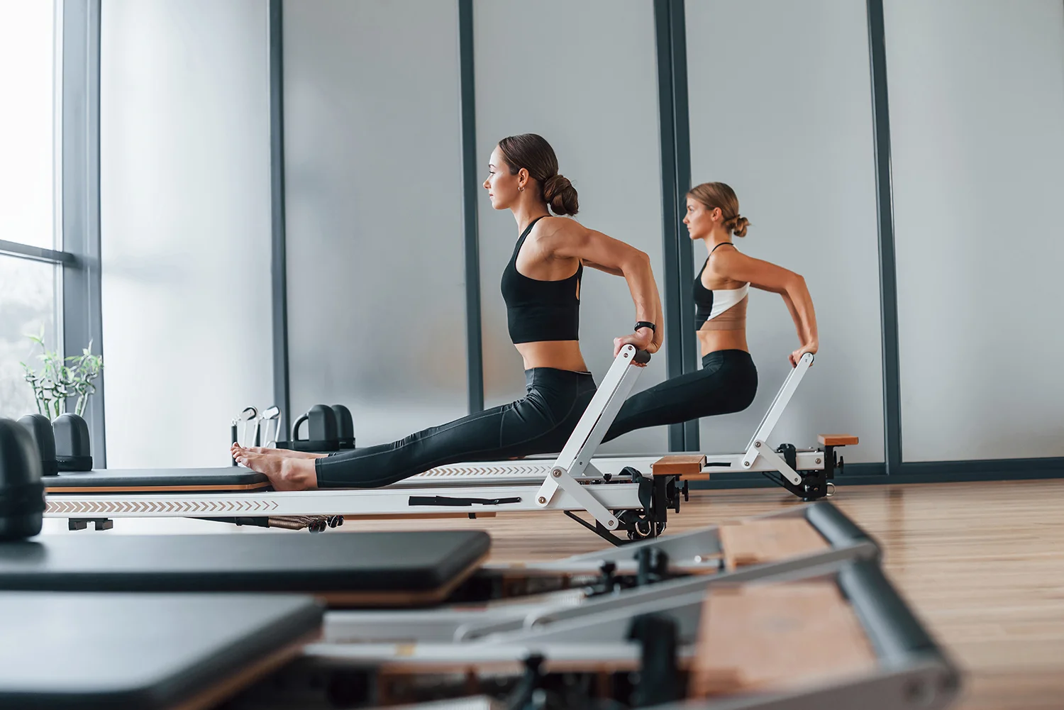 women doing pilates exercise in the modern gym